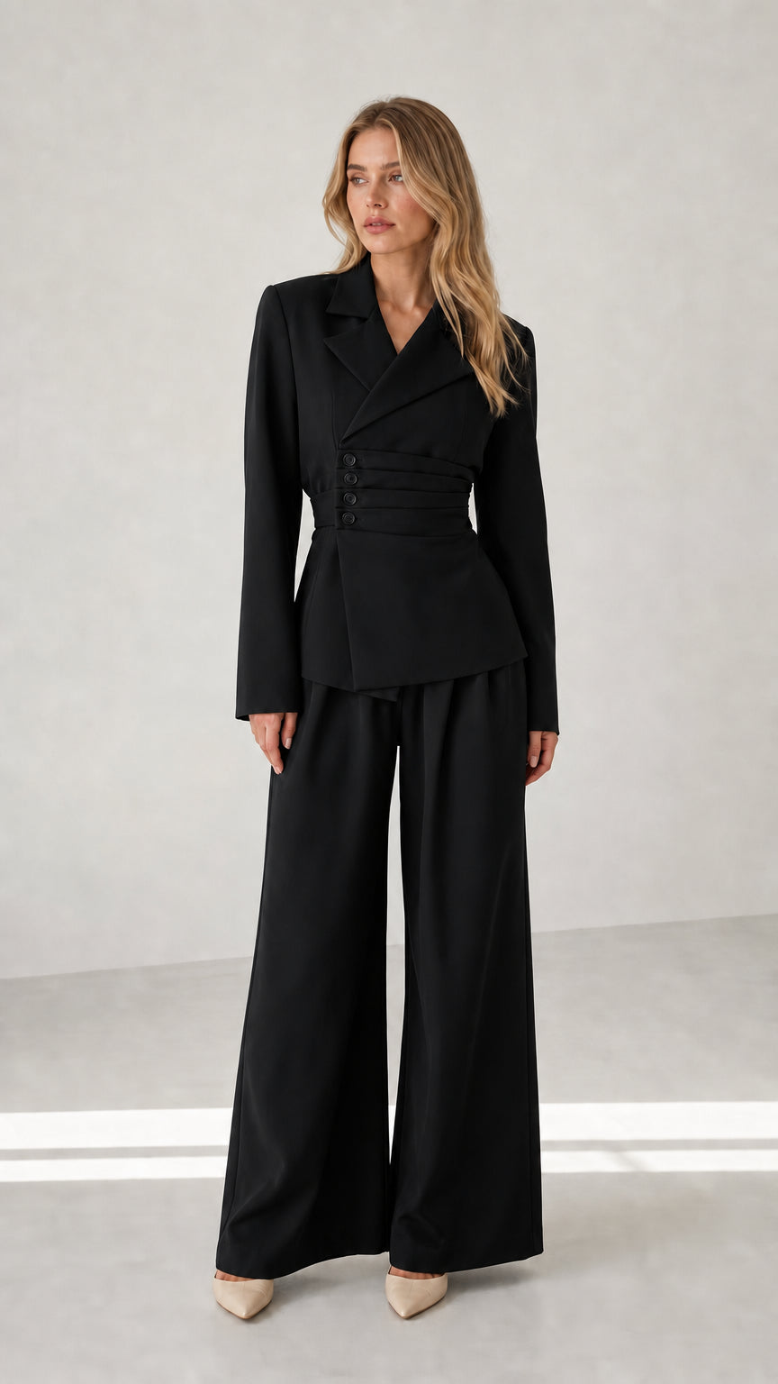 Woman wearing black cinched waist blazer and wide leg suit set