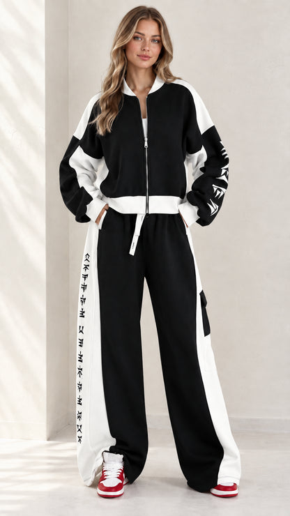 Full front view of model wearing black and white colorblock zip-up tracksuit set