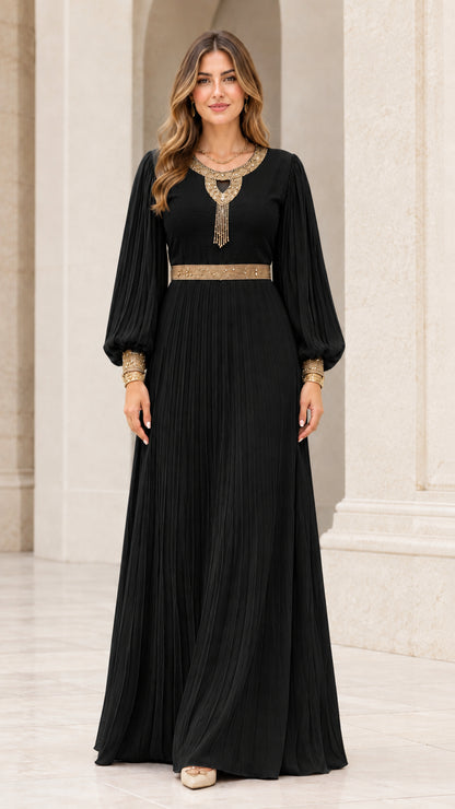 Front view of black pleated long sleeve maxi dress with gold embroidered accents