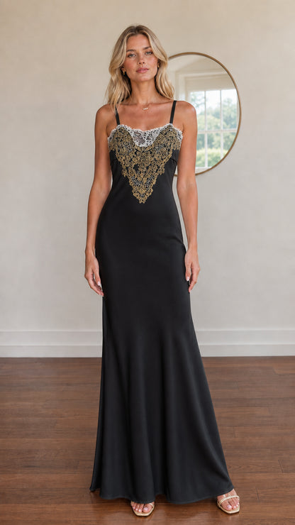Model wearing black satin maxi dress with gold embroidered bodice