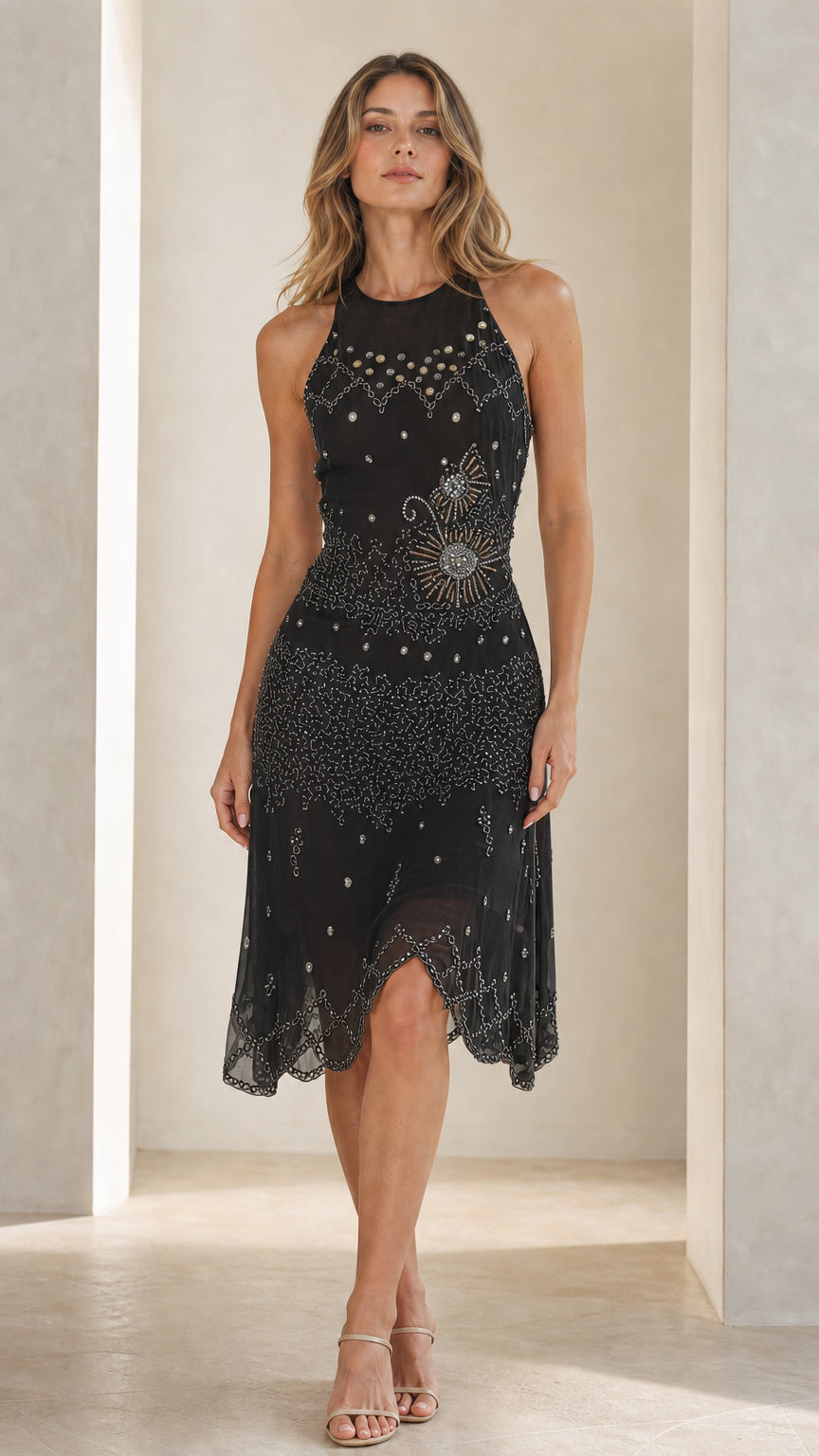 Front view of model in black embellished halter midi dress