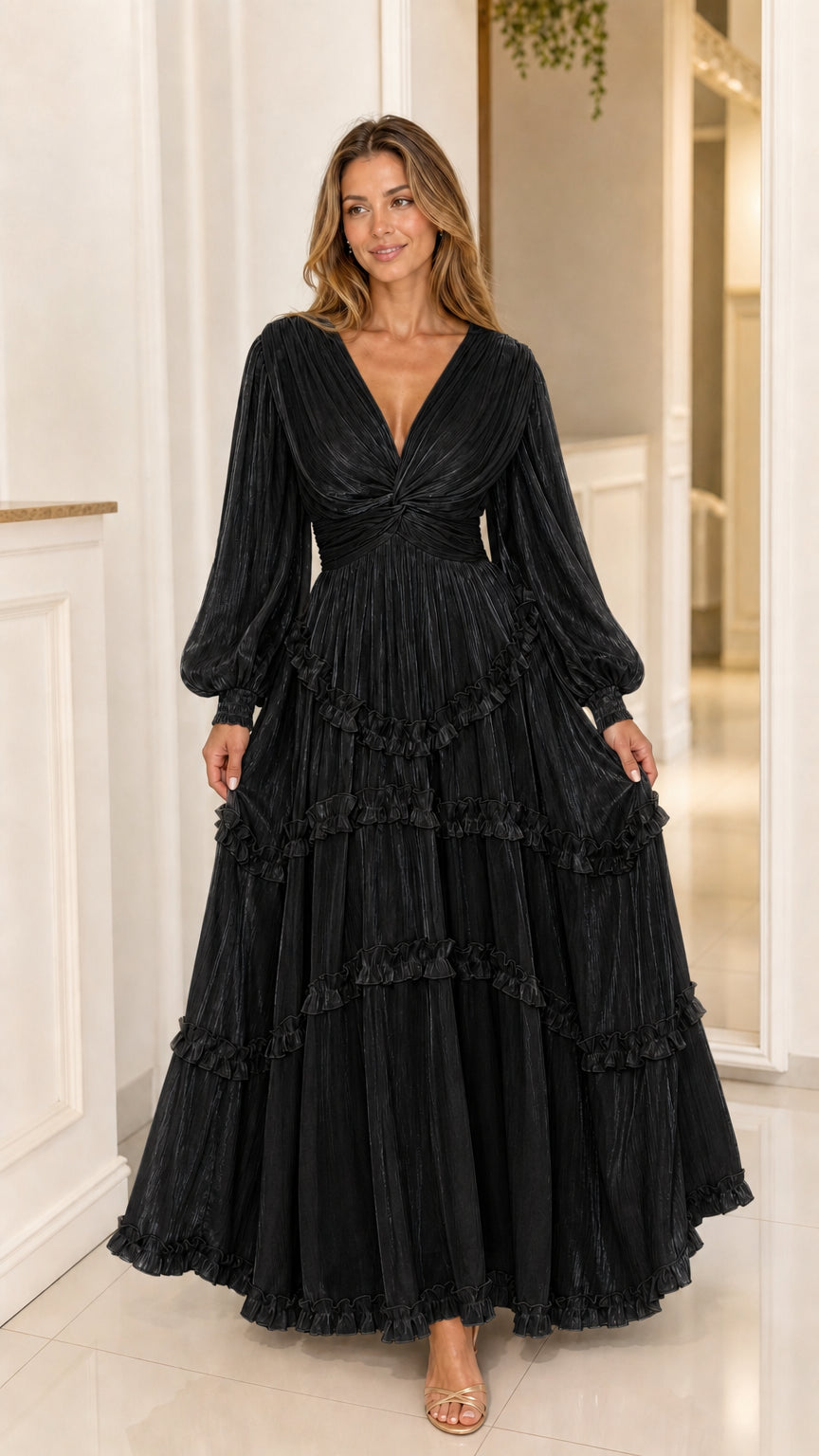Front view of Black pleated shimmer long sleeve tiered maxi gown
