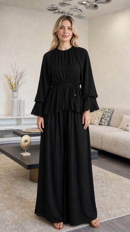Front view of woman wearing Black pleated peplum wide leg pants set