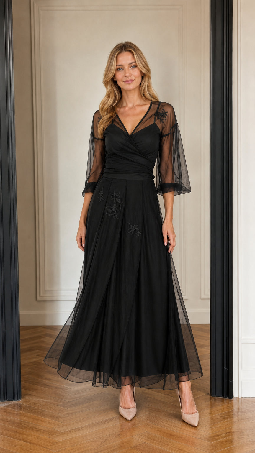 Model wearing black floral embroidered tulle maxi evening gown