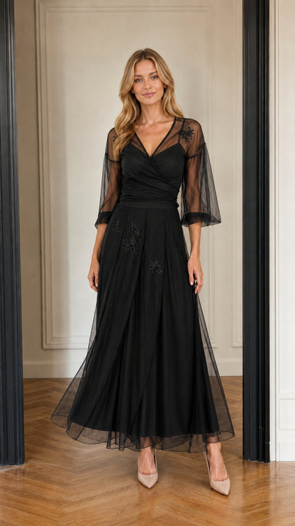Model wearing black floral embroidered tulle maxi evening gown