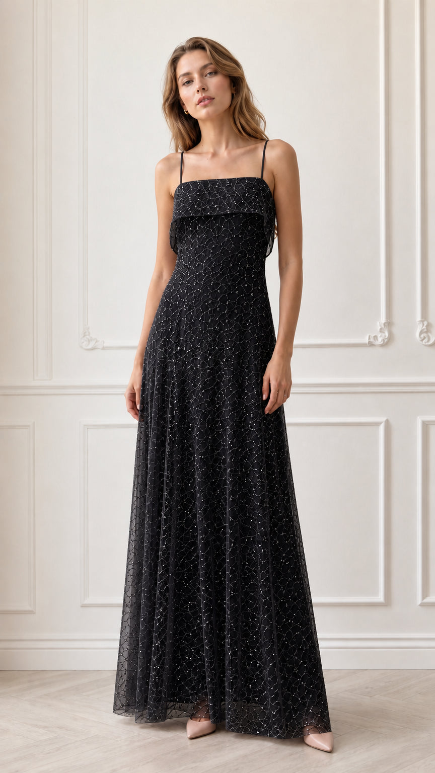 Model wearing black sequin embroidered spaghetti strap maxi evening dress