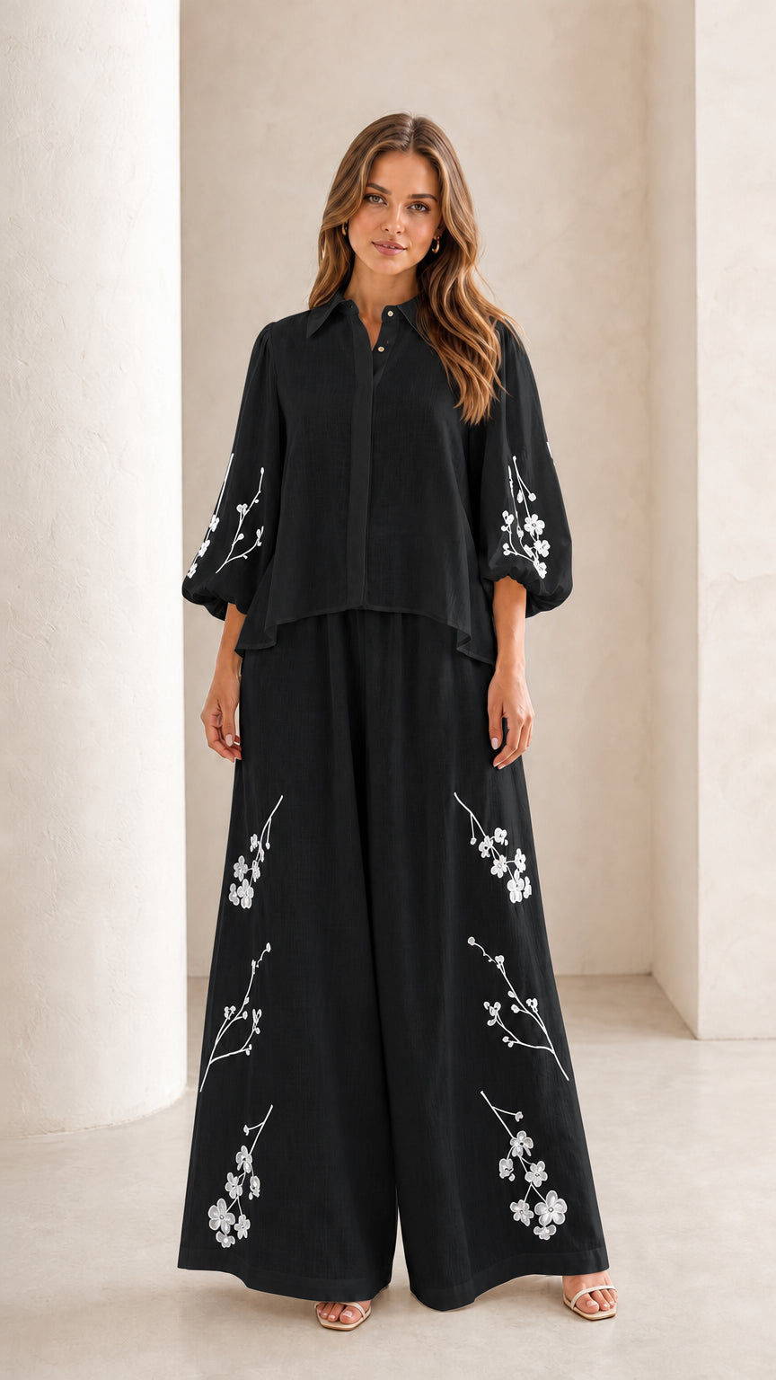 Front view of woman wearing black floral embroidered two-piece set