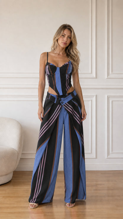 Model wearing black multi striped corset top and wide-leg pants