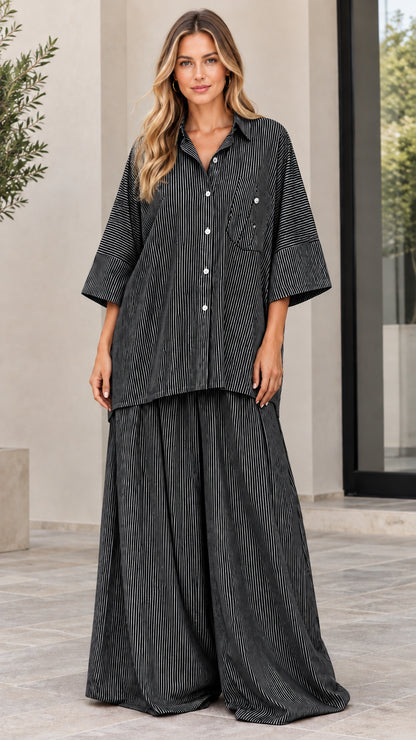 Woman wearing black and white striped matching shirt and pants two-piece set