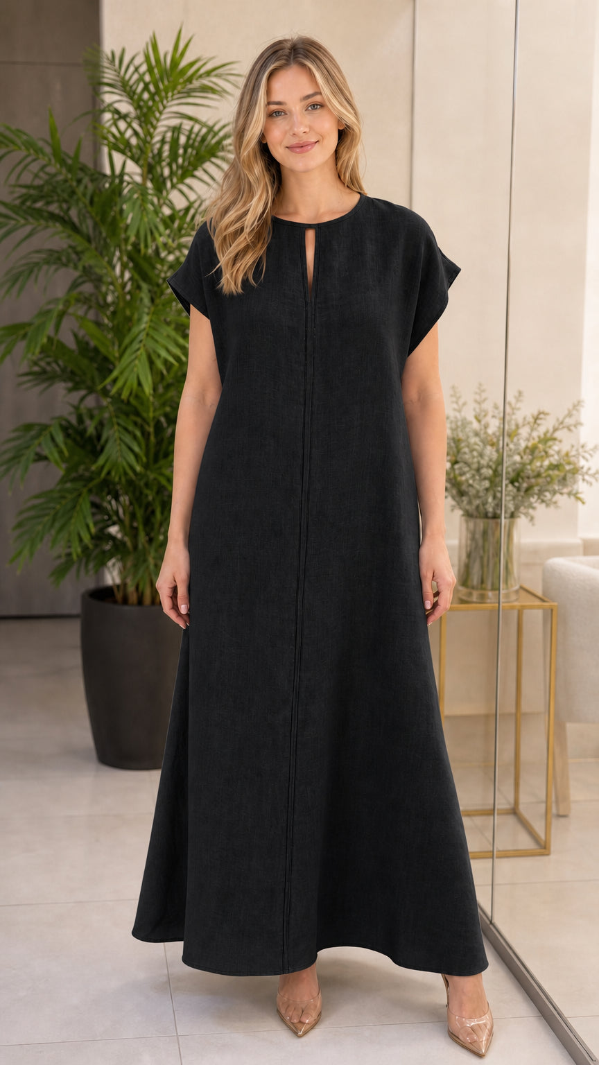 Woman wearing black short-sleeve linen-look maxi dress