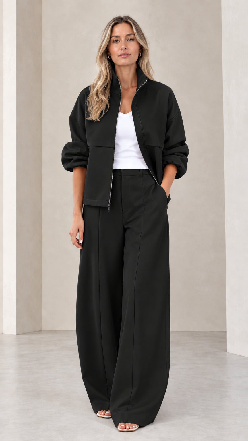 Full front view of women's black zip-up jacket and wide-leg pants two-piece set