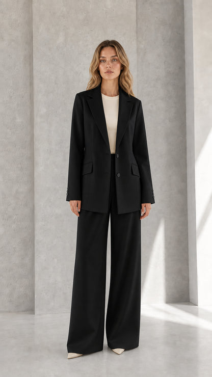 Woman wearing black tailored single-breasted blazer and wide-leg pants suit set