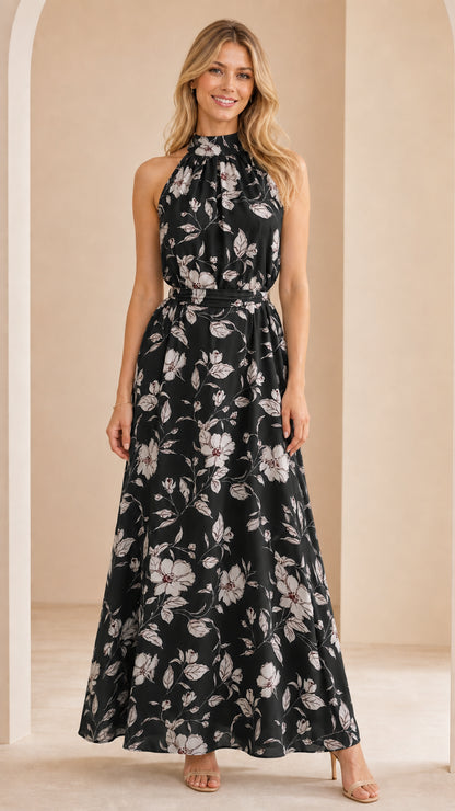 Front view of woman wearing black floral halter neck maxi dress