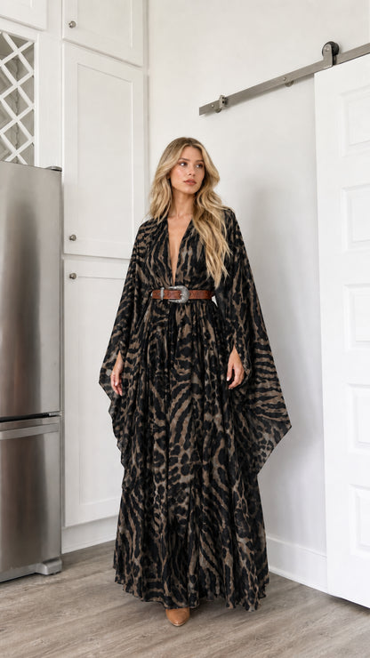 Woman wearing black animal print kimono maxi dress with draped sleeves