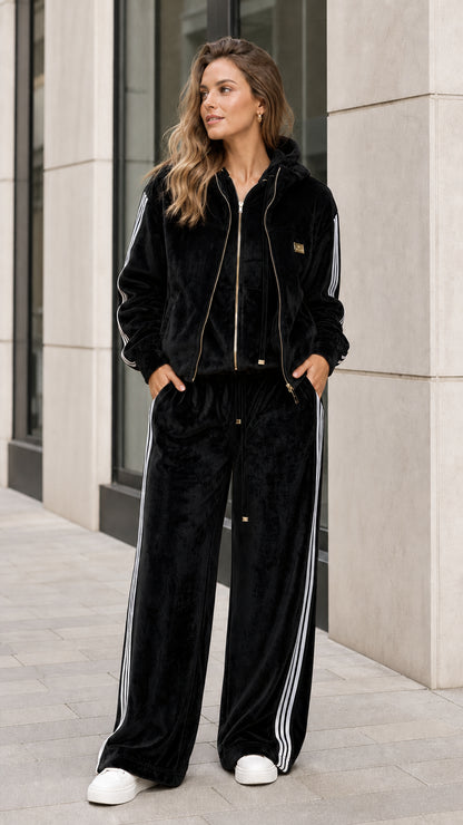 Full front view of black velour two-piece tracksuit set with white side stripes