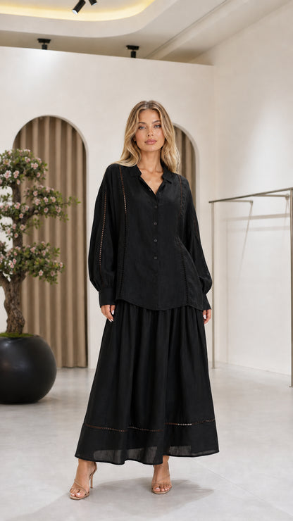 Front view of the black women's blouse and maxi skirt two-piece set