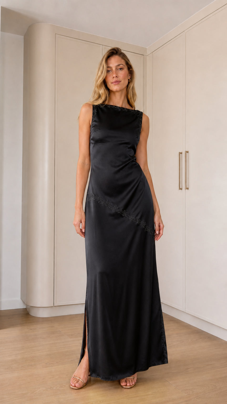 Front full-length view of model wearing black sleeveless satin maxi dress