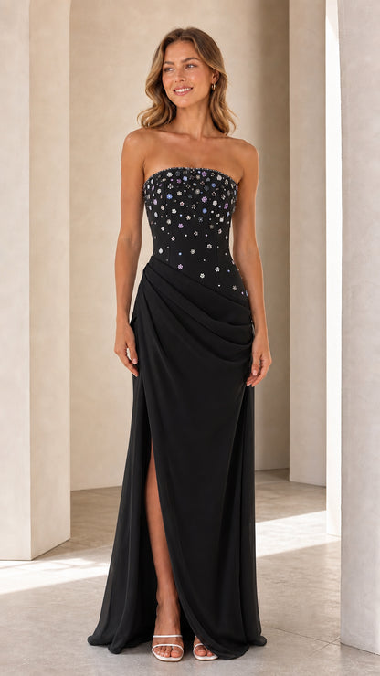 Model wearing Black strapless beaded bodice evening gown with draped skirt and slit