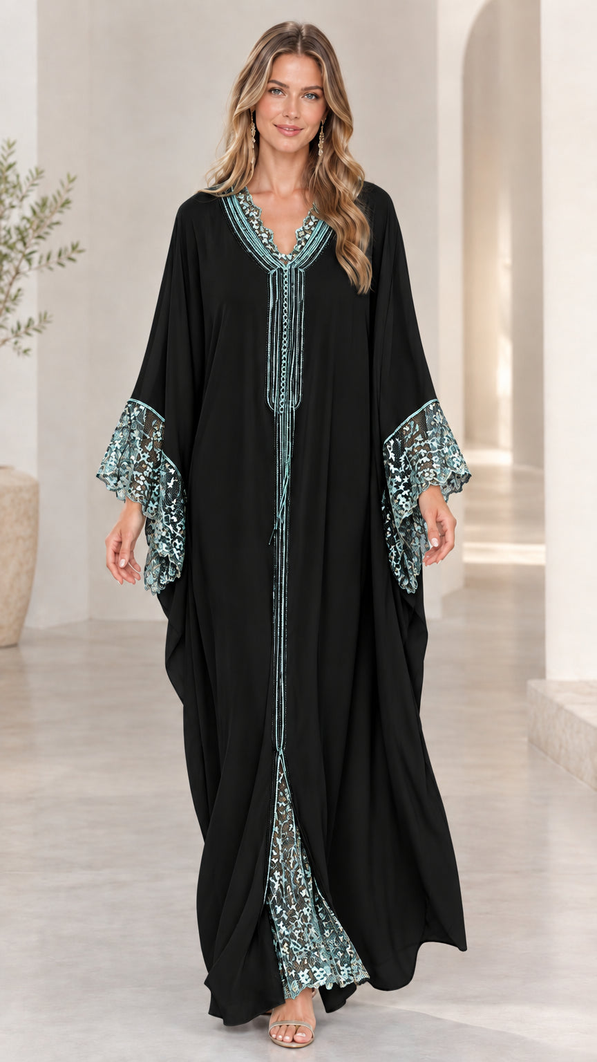 Model wearing black caftan maxi dress with contrasting lace details