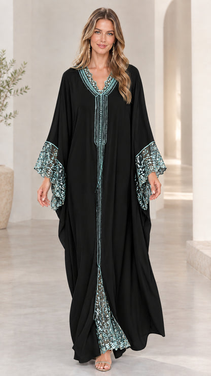 Model wearing black caftan maxi dress with contrasting lace details