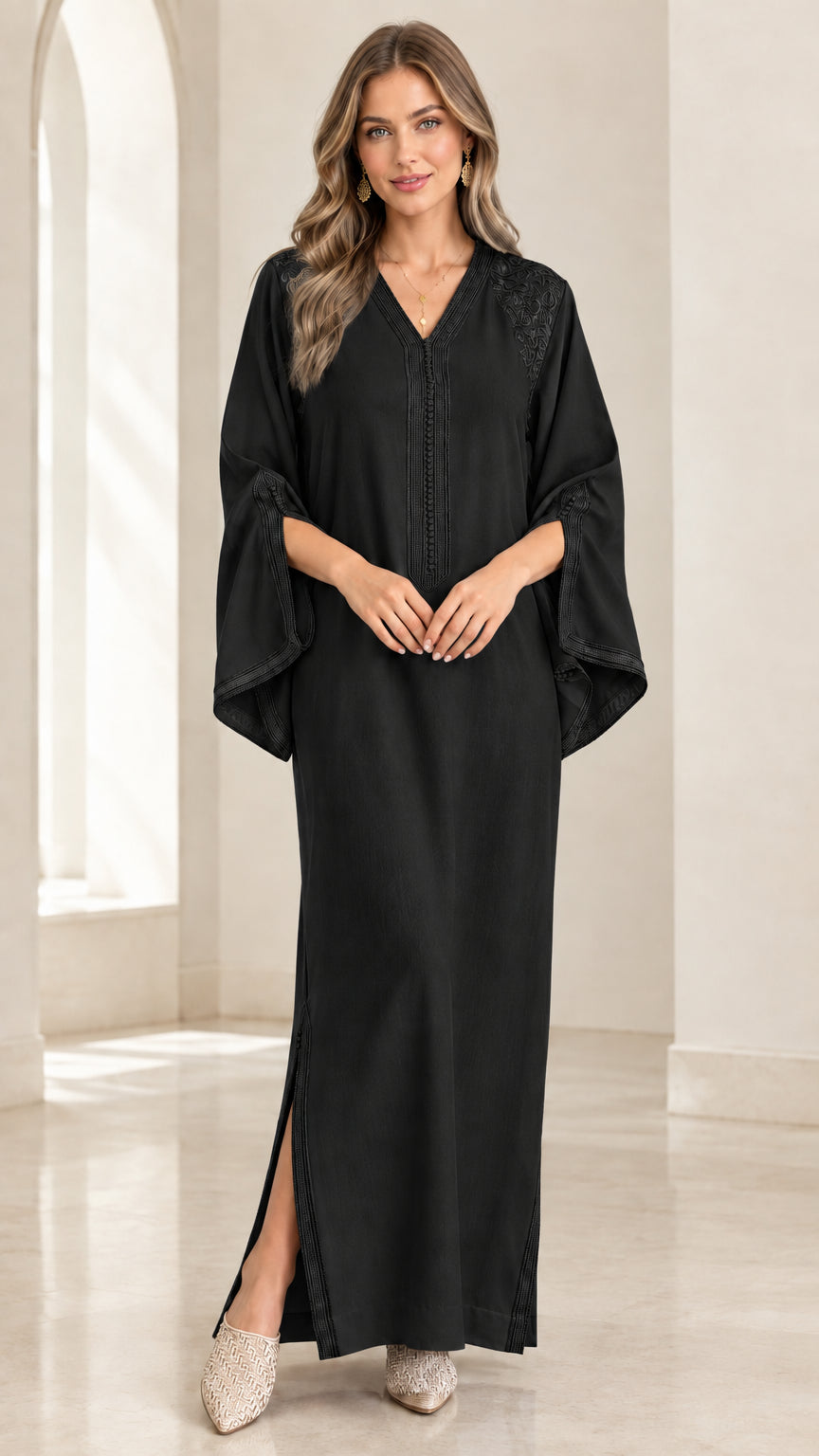 Front full-length view of woman wearing Black embroidered kaftan maxi dress