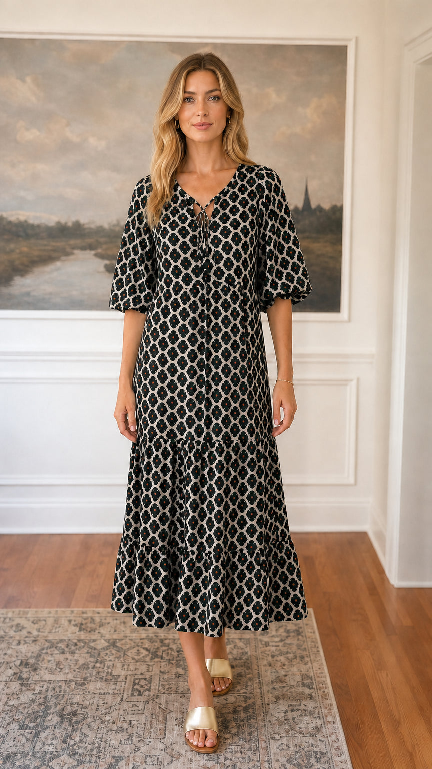Front view of black floral tiered midi dress