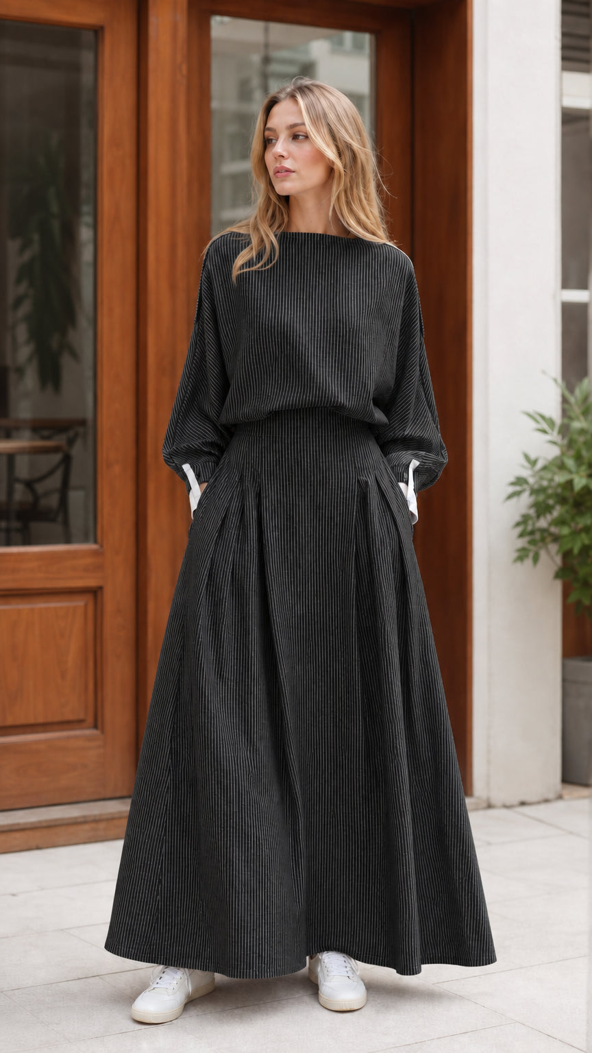 Model wearing black and white striped long sleeve maxi dress