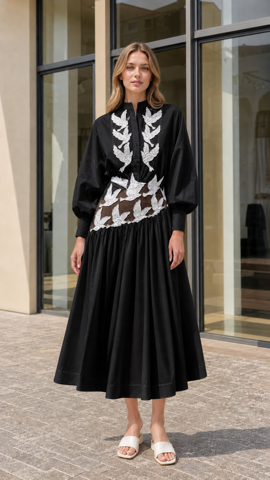 Model wearing black embroidered cutout midi shirt dress with balloon sleeves