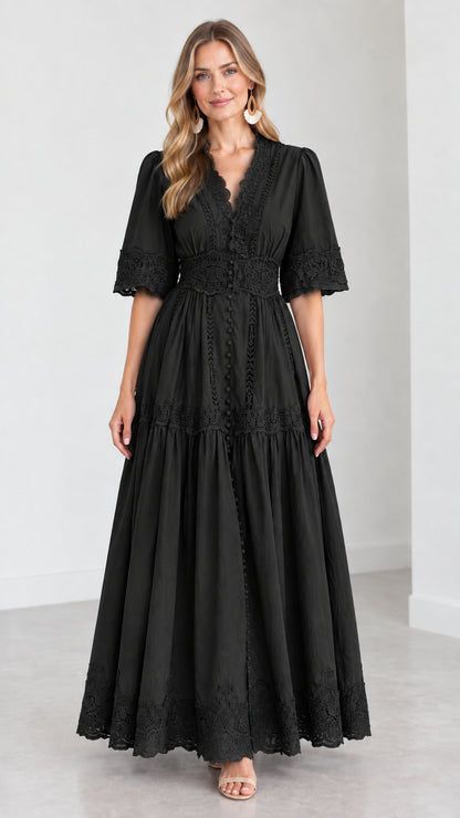 Front view of woman wearing a black V-neck lace trim tiered maxi dress