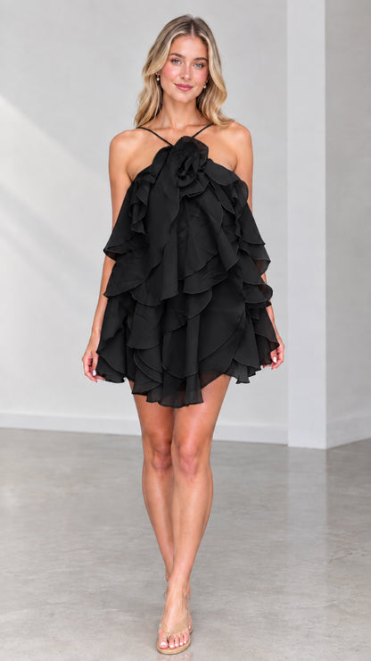 Front view of model wearing Black tiered ruffle halter mini dress