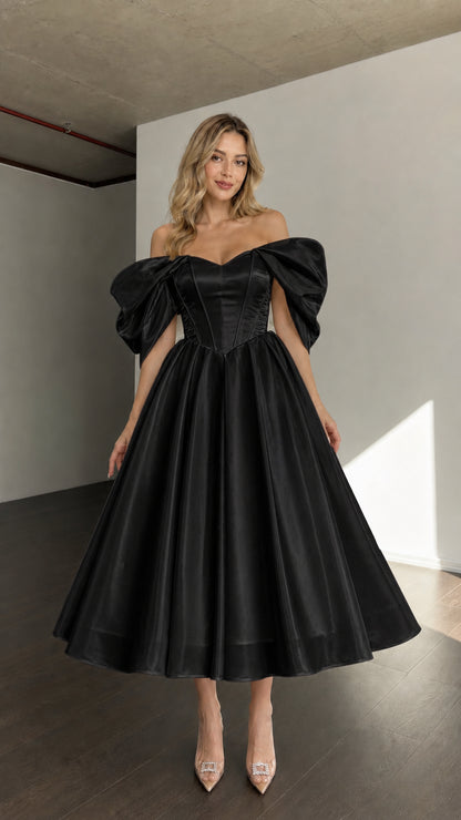 Front view of woman wearing black off-shoulder corset midi dress