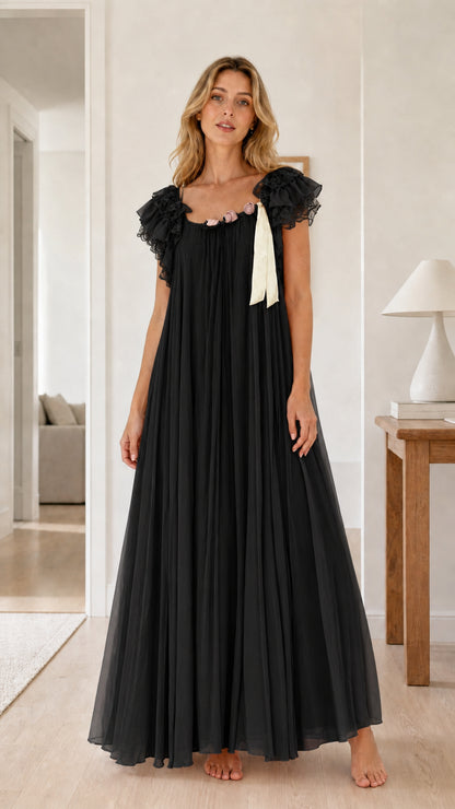 Full front view of black pleated maxi nightgown dress with lace sleeves and rosette details