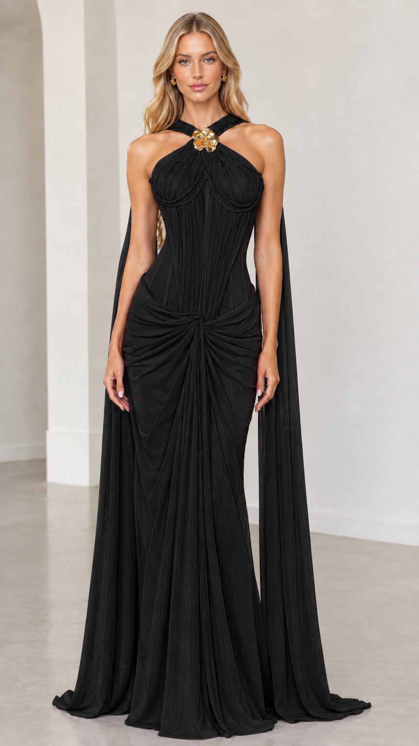 Front view of black halter corset maxi evening gown with shoulder cape panels