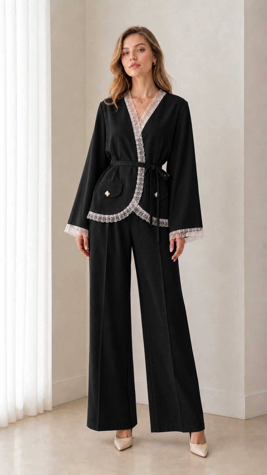 Front view of woman wearing black lace trim wrap blazer and wide leg pant set
