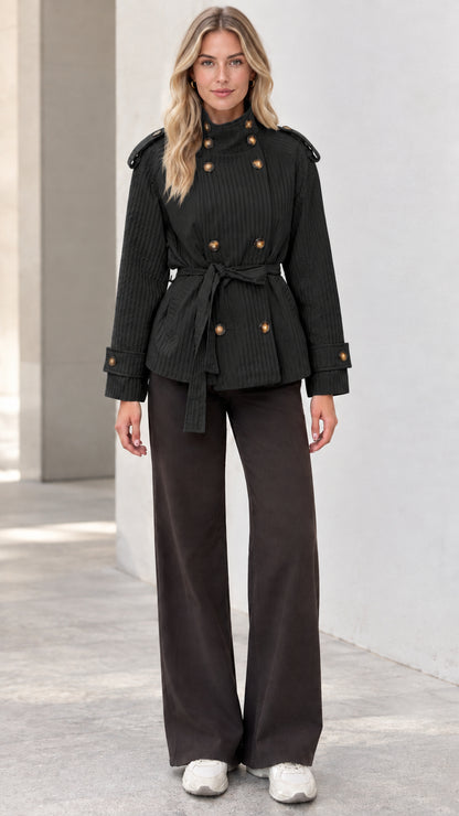 Full front view of model wearing black double-breasted belted short trench jacket