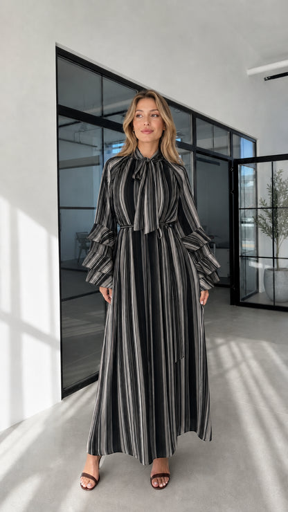 Model wearing black striped ruffle sleeve maxi dress front view