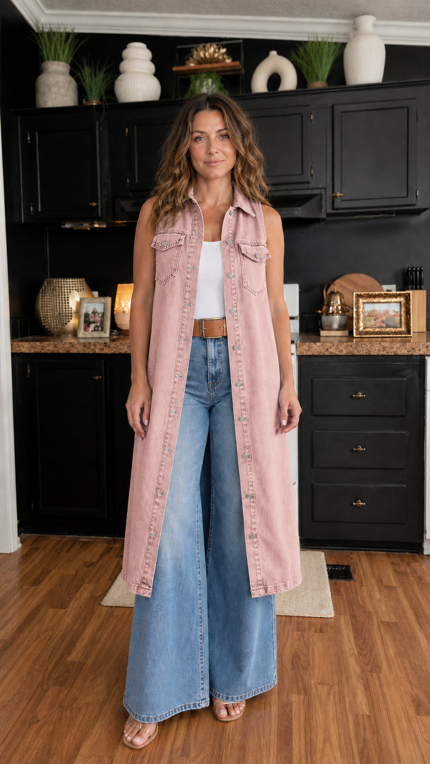Woman wearing pink longline denim vest over white top