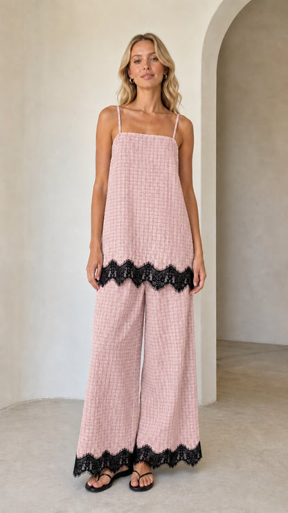 Model wearing pink plaid two-piece set with black lace hem