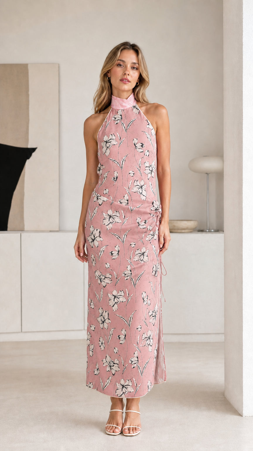 Woman wearing pink floral halter maxi dress