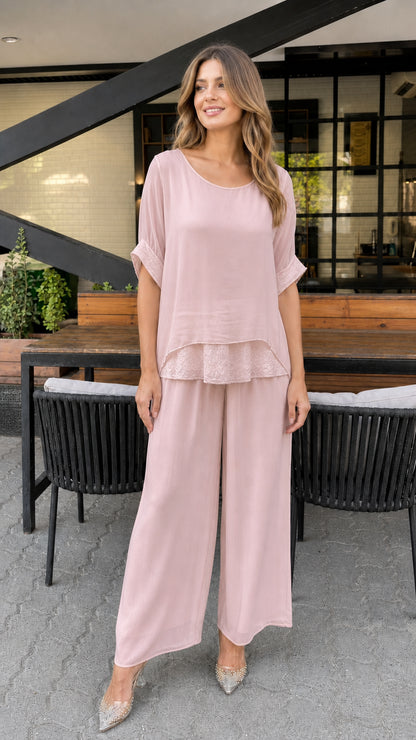 Model wearing pink layered tunic and wide-leg pants set
