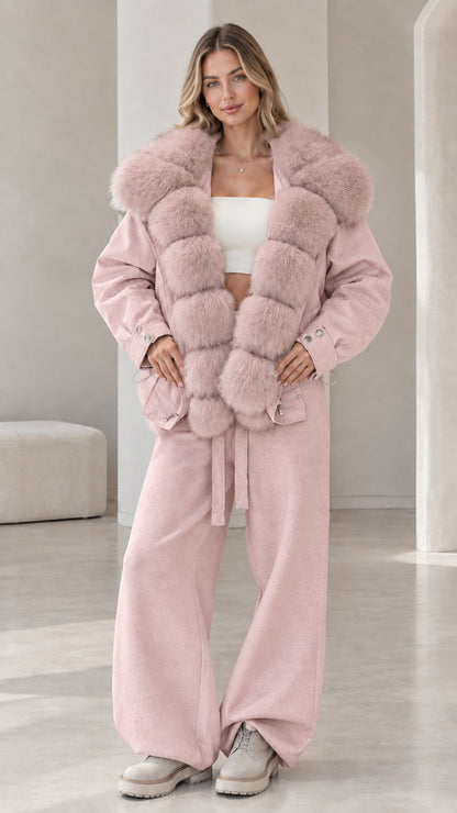 Model wearing dusty pink jacket set with tonal plush faux fur collar