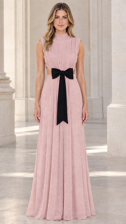 Front view of model wearing dusty rose pleated evening maxi dress with black bow