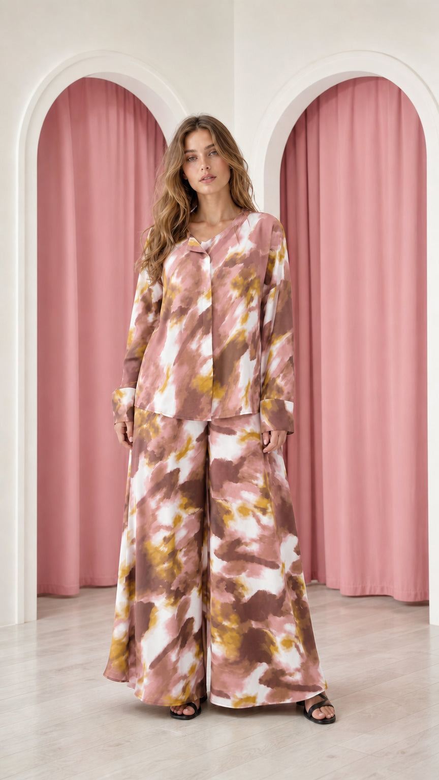 Model wearing dusty rose tie-dye satin top and wide-leg trousers set
