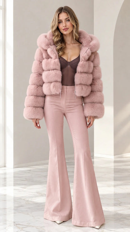Model wearing dusty blush pink cropped hooded faux fur jacket with pink flare pants