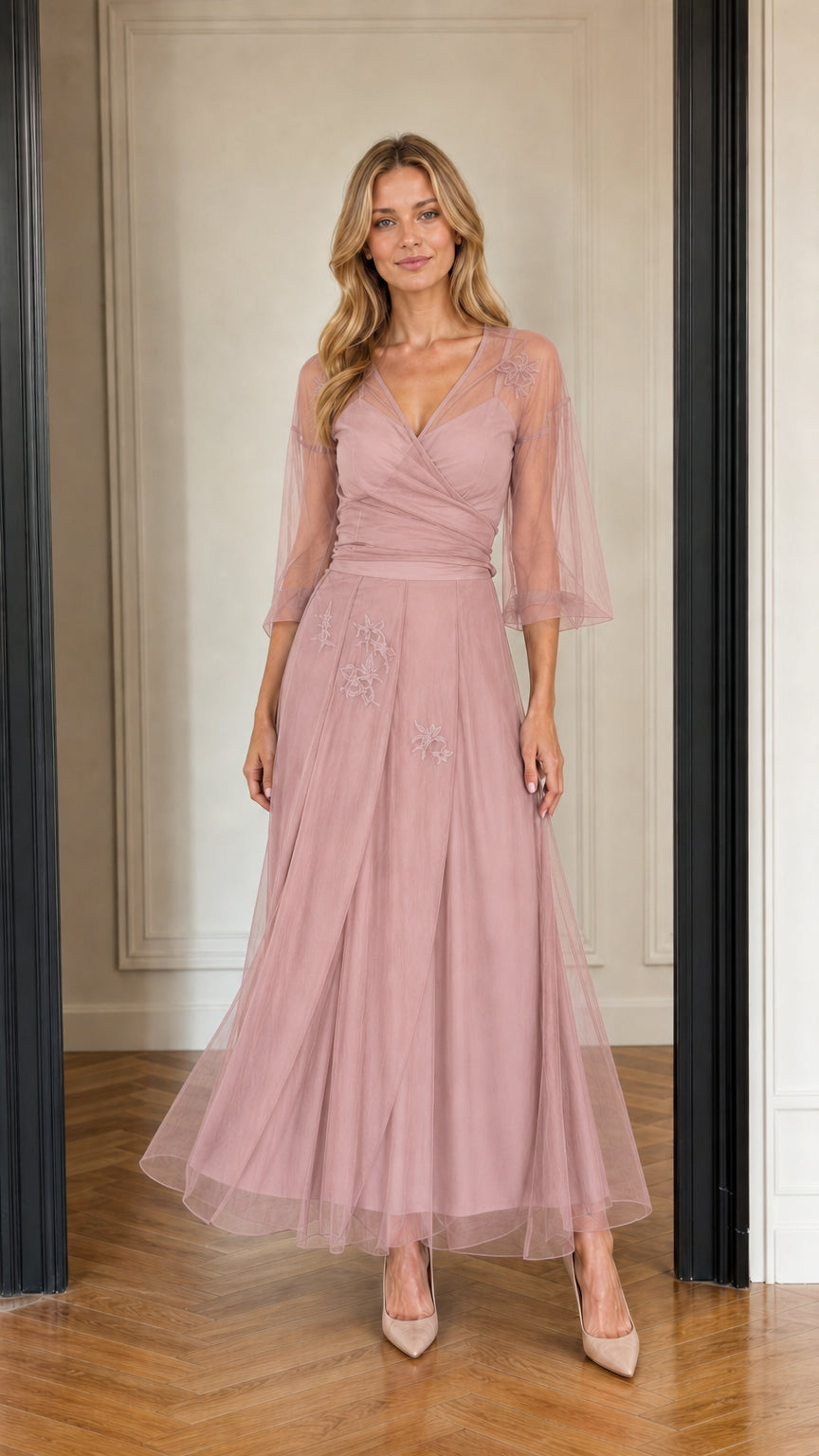 Model wearing dusty rose tulle maxi dress with sheer sleeves