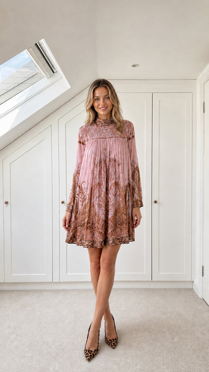 Model wearing dusty pink paisley pleated high-neck mini dress