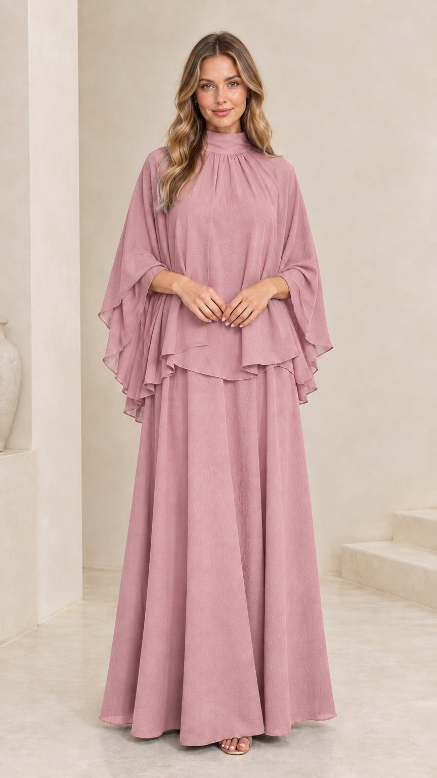 Model wearing dusty pink mock neck cape overlay maxi dress