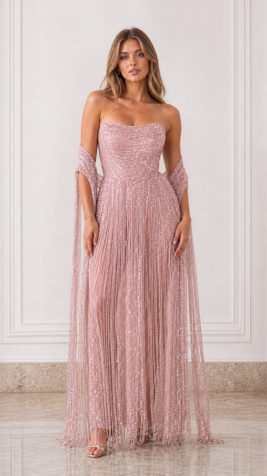 Full-length front view of dusty pink strapless beaded fringe maxi dress