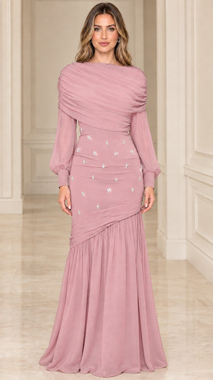 Model wearing dusty rose pink draped long sleeve evening maxi dress