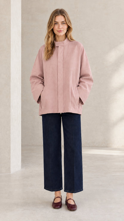 Front view of woman wearing dusty pink stand collar casual minimalist jacket